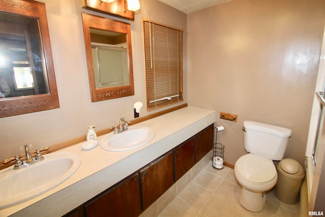 bathroom featuring vanity, tile patterned flooring, and toilet