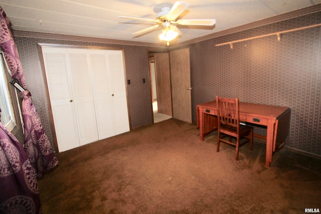 office with dark colored carpet, ceiling fan, and crown molding