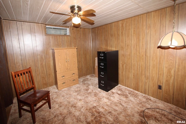 living area featuring carpet flooring, wood walls, ceiling fan, and wood ceiling