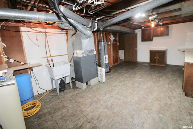 basement featuring water heater and heating unit