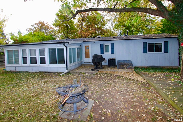 back of property featuring central AC unit and a patio