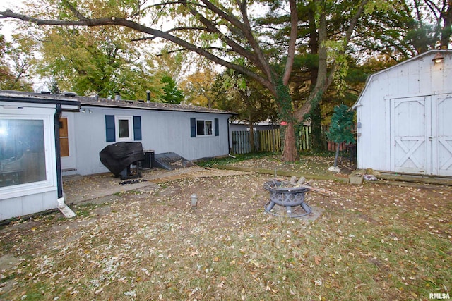 view of yard with a fire pit and a shed