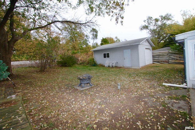 view of yard featuring an outdoor fire pit and a shed