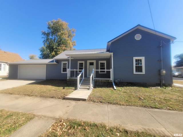 view of front of house featuring a front yard, a garage, and a porch