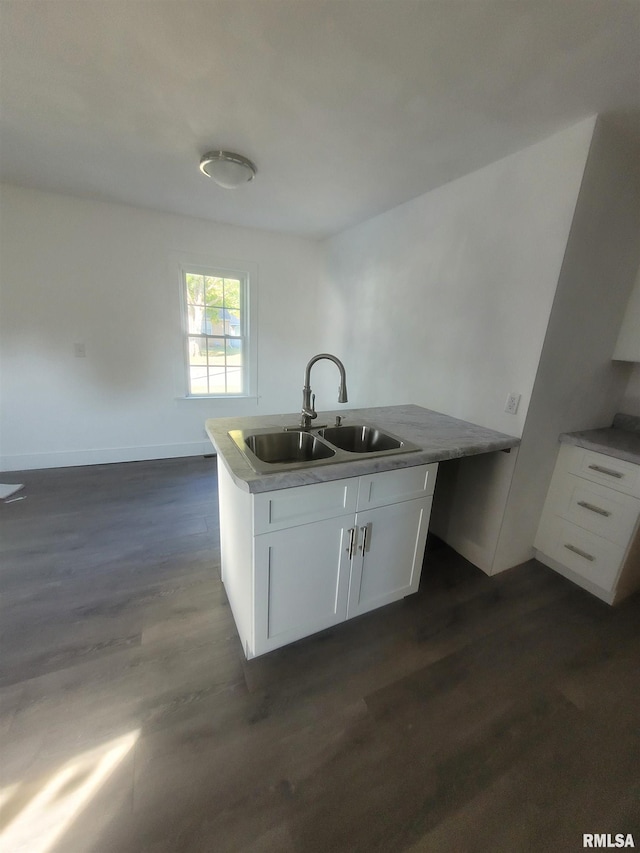 kitchen featuring sink, white cabinets, and dark wood-type flooring