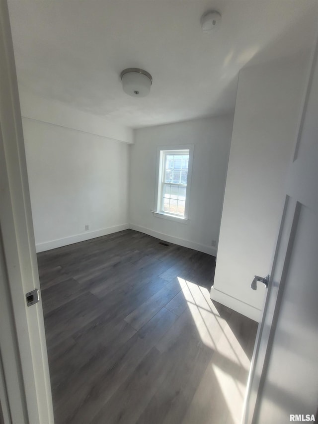 435 N Ave B Ave, Canton, IL 61520 - empty room with baseboards and dark wood-type flooring