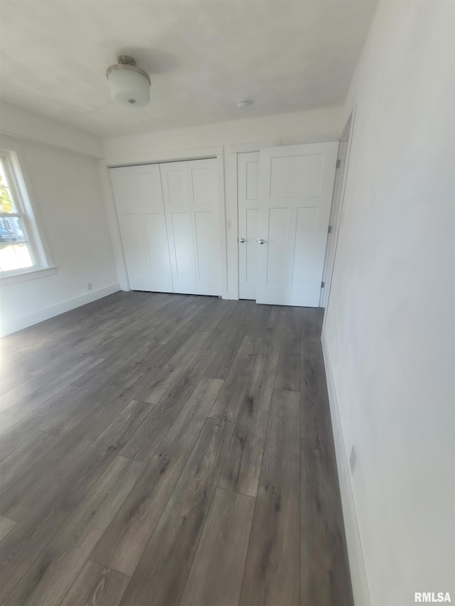 unfurnished bedroom featuring dark hardwood / wood-style flooring