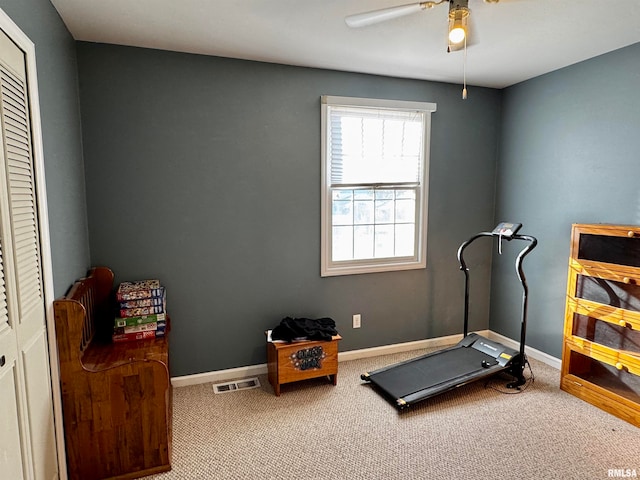 exercise area with carpet flooring and ceiling fan