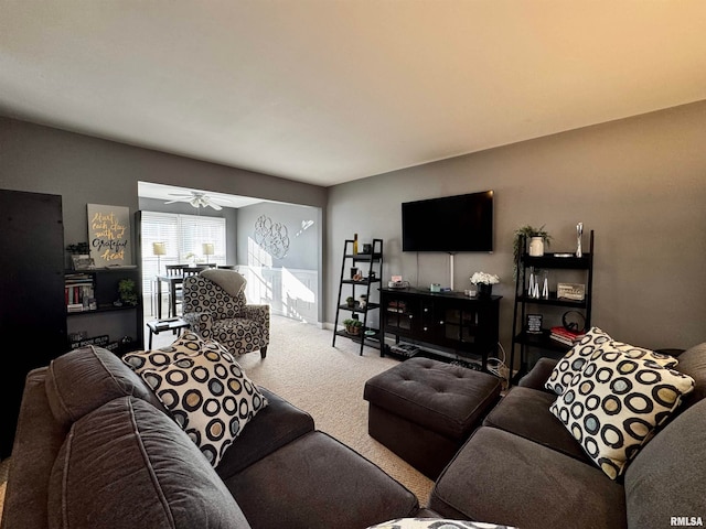 living room featuring ceiling fan and carpet floors