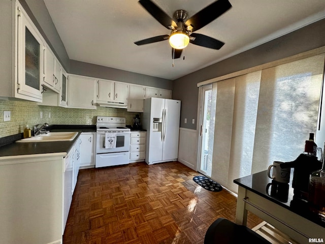 kitchen featuring white appliances, tasteful backsplash, white cabinetry, and sink