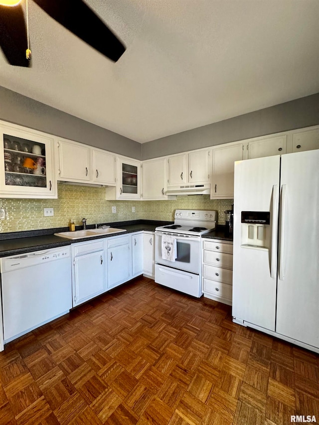 kitchen featuring white appliances, sink, backsplash, dark parquet floors, and white cabinets