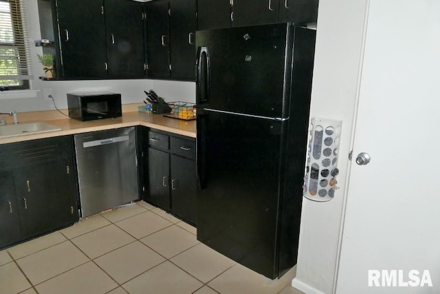 kitchen featuring light tile patterned flooring, black appliances, and sink