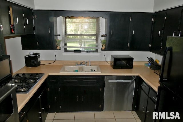 kitchen featuring light tile patterned flooring, black appliances, and sink