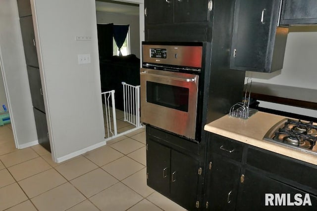 kitchen with light tile patterned flooring and stainless steel appliances