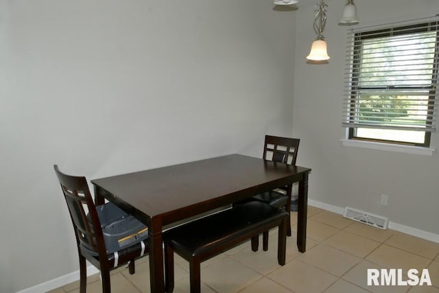 dining space featuring light tile patterned floors