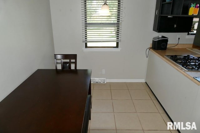 kitchen featuring light tile patterned flooring and black gas cooktop