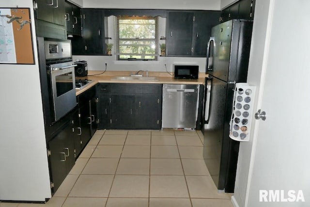 kitchen featuring sink, black appliances, and light tile patterned flooring