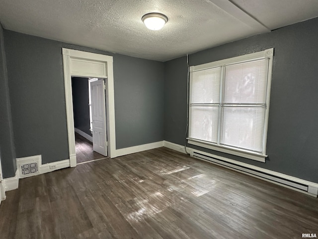 unfurnished bedroom featuring a textured ceiling, a baseboard radiator, and dark hardwood / wood-style floors