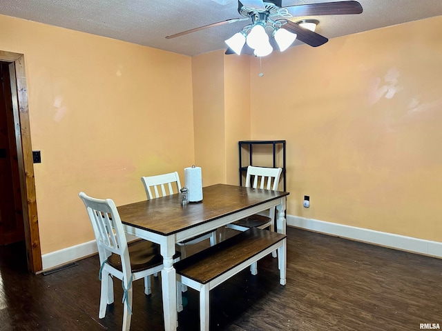 dining space with ceiling fan, a textured ceiling, and dark hardwood / wood-style flooring