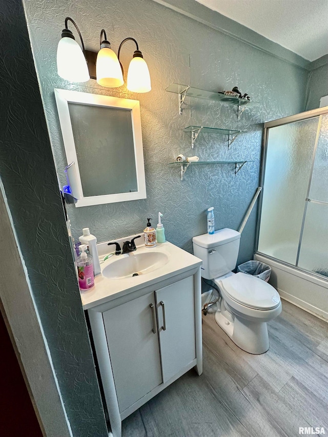 full bathroom with vanity, enclosed tub / shower combo, toilet, and wood-type flooring