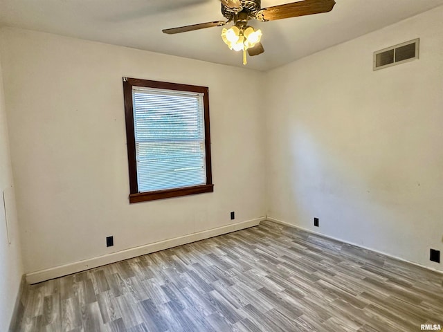 spare room featuring light hardwood / wood-style floors and ceiling fan