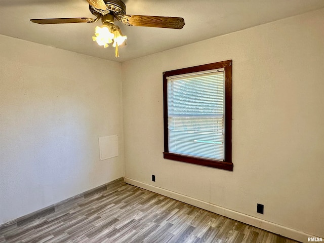 empty room with light hardwood / wood-style flooring and ceiling fan