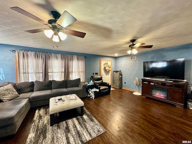 living room with a textured ceiling and dark wood-type flooring