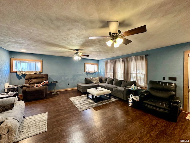 living room with ceiling fan, a textured ceiling, and dark hardwood / wood-style flooring