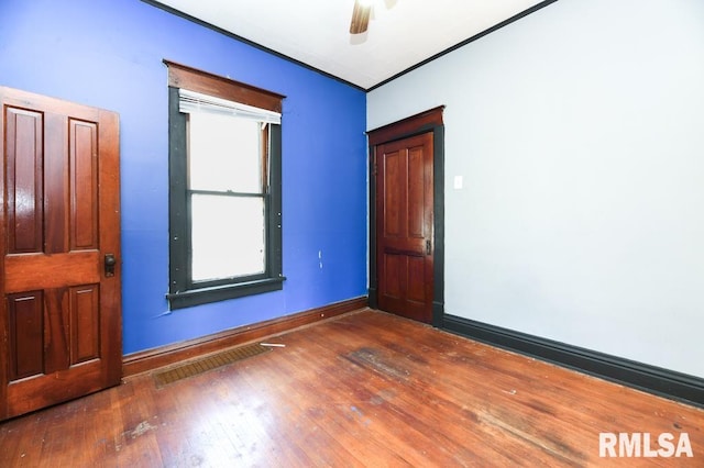 unfurnished room with ceiling fan and dark hardwood / wood-style flooring