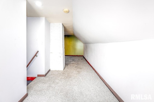 additional living space featuring light carpet and lofted ceiling