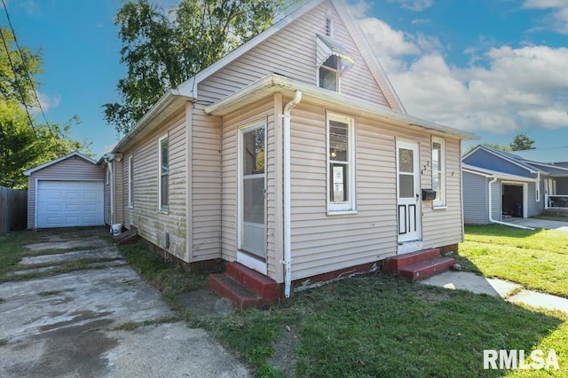 view of front of property with an outdoor structure, a front yard, and a garage