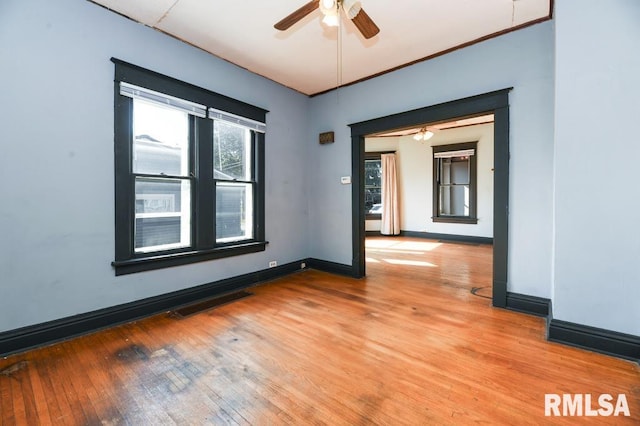 empty room featuring ceiling fan and light hardwood / wood-style flooring