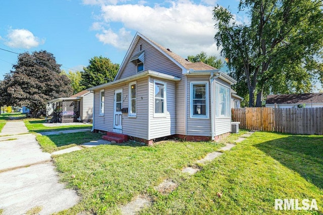 view of property exterior with a yard and central AC unit