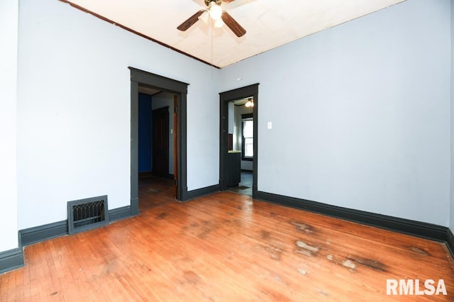 empty room with wood-type flooring and ceiling fan