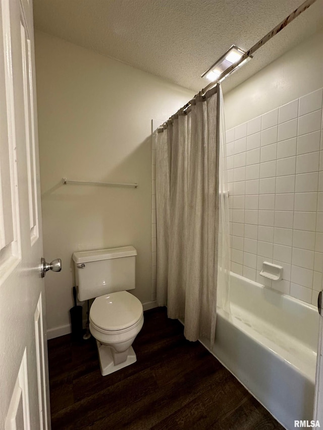 bathroom featuring toilet, wood-type flooring, a textured ceiling, and shower / tub combo with curtain