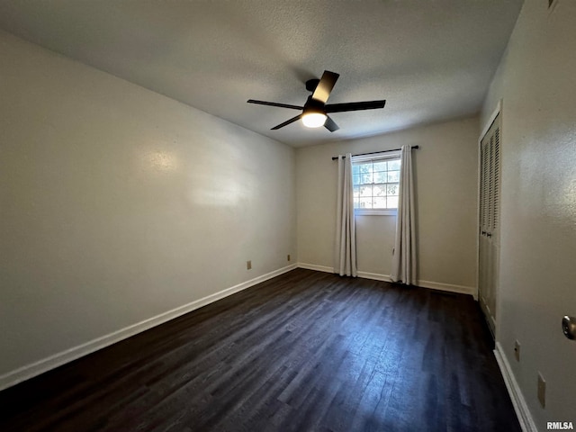 spare room featuring ceiling fan, a textured ceiling, and dark hardwood / wood-style flooring