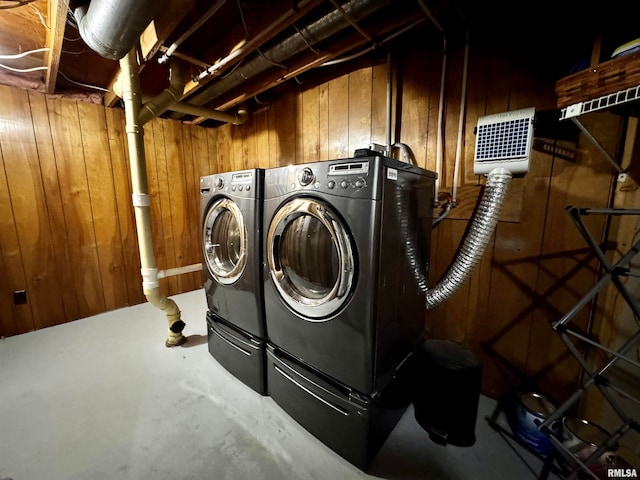 laundry area featuring independent washer and dryer and wooden walls