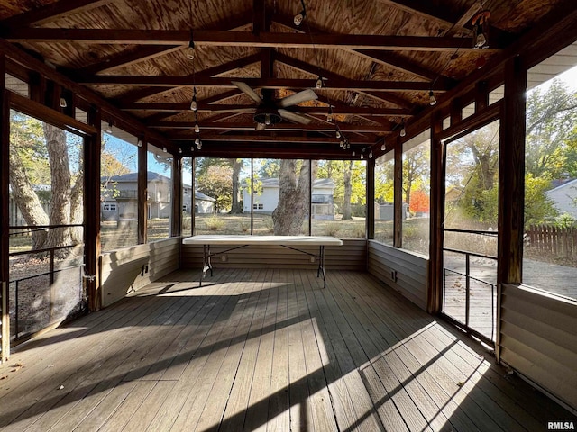 unfurnished sunroom with lofted ceiling with beams