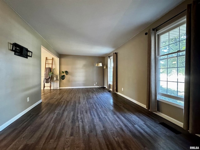 spare room with dark wood-type flooring