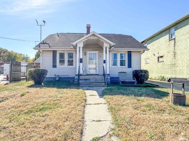 bungalow-style house featuring a front lawn