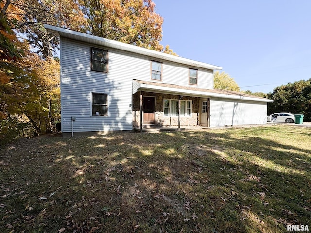 back of property featuring a lawn and a porch