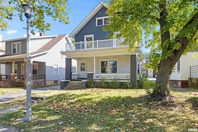 view of front of property with a porch, a balcony, and a front lawn