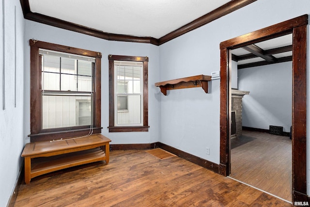 interior space with ornamental molding and dark wood-type flooring