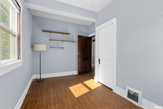 spare room with dark hardwood / wood-style flooring