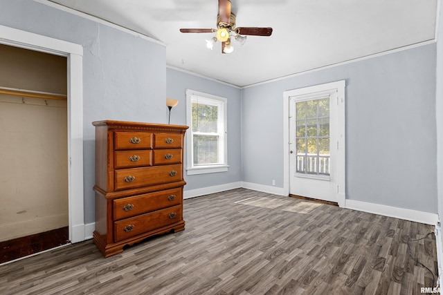 unfurnished bedroom featuring a closet, ceiling fan, ornamental molding, and hardwood / wood-style floors