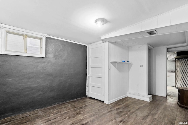 basement featuring washer / clothes dryer and dark hardwood / wood-style flooring