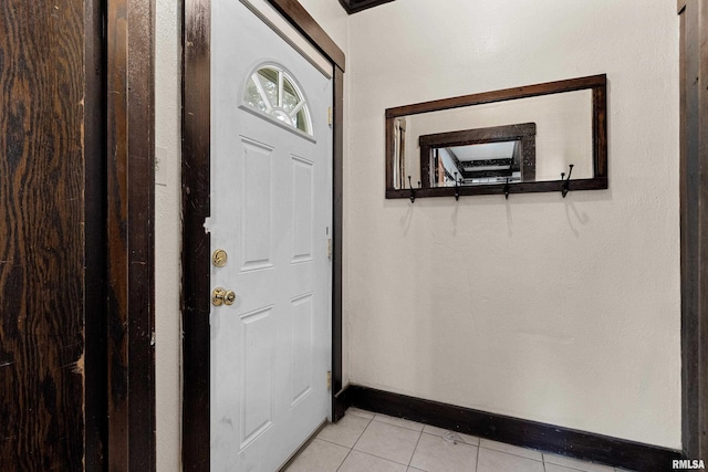 doorway to outside with light tile patterned flooring