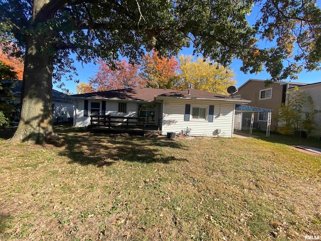 back of house with a wooden deck and a yard