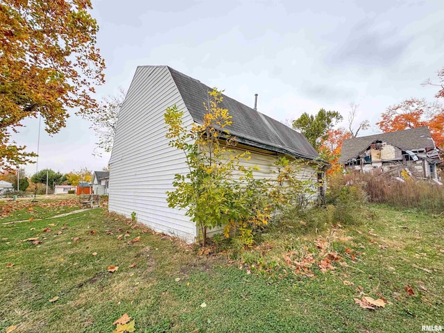 view of side of property with a yard