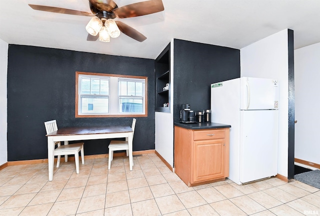 kitchen featuring ceiling fan, white fridge, built in shelves, and light tile patterned floors